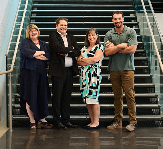 A professor and student look at a computer screen in a laboratory